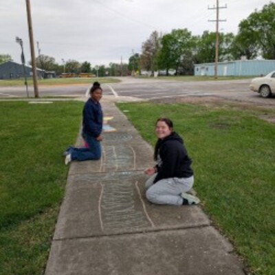 High School Volunteers creating the Chalk Obstacle Course for Community Service Hours!