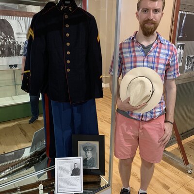 Grant Timmerman next to his great-uncle's uniform, Medal of Honor recipient Sgt. Grant Timmerman