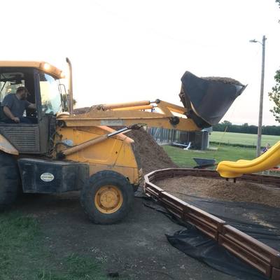 Putting wood chips down around the equipment. 