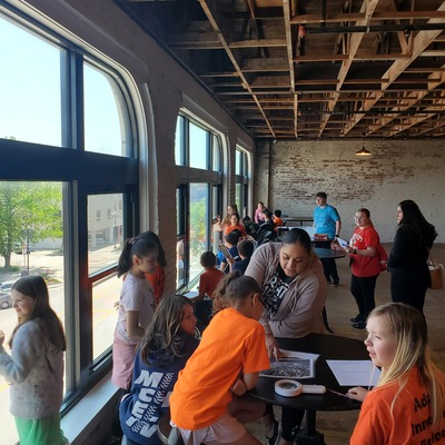 Students compare then and now using a 1920s photo and what they see out the third floor windows.