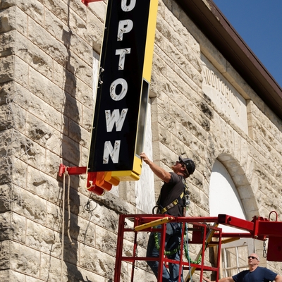 Attaching the neon sign to the building